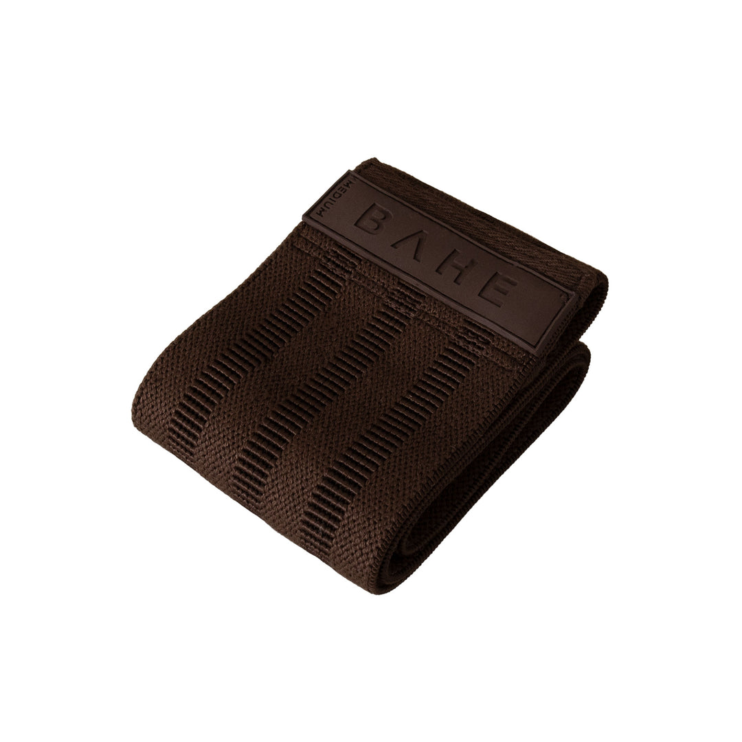 A dark brown textured fabric booty band with a matching brown leather tab embossed with the brand name &