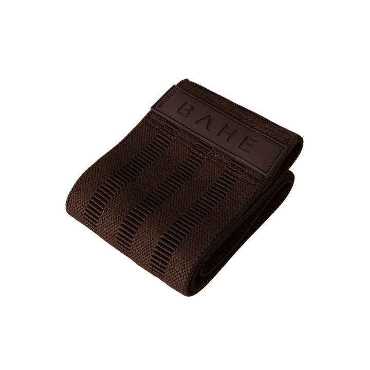 A dark brown textured fabric booty band with a matching brown leather tab embossed with the brand name &