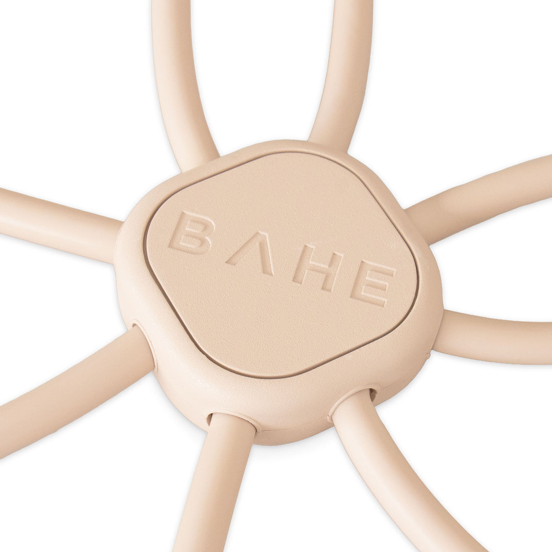 Close-up of a beige silicone hexagonal flow reformer piece embossed with the brand name BAHE.